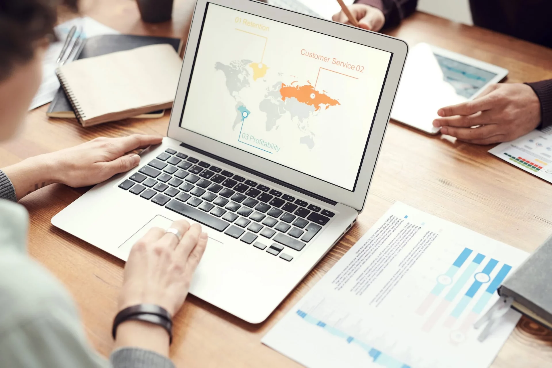 Consultant using laptop with a world map on the screen
